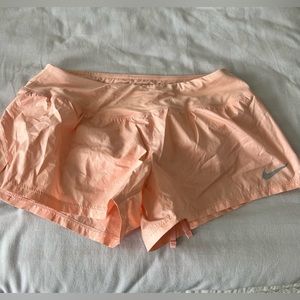 Peach Nike running shorts